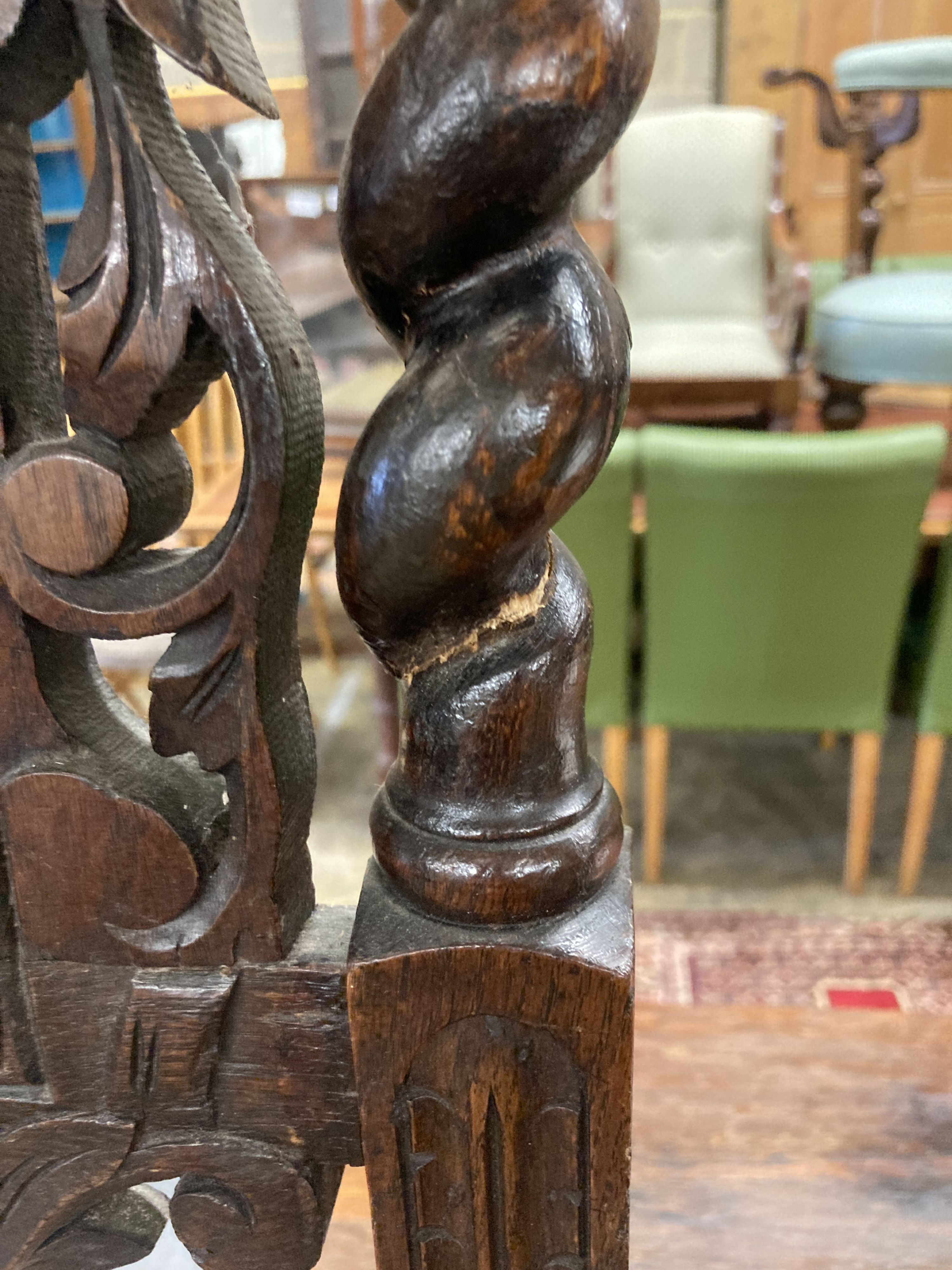 A pair of late 19th century Flemish carved oak panel backed dining chairs